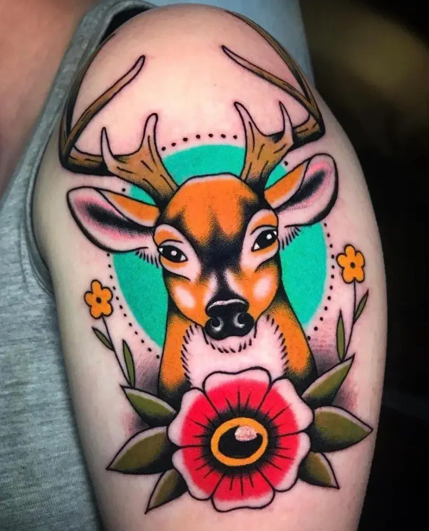 A tattoo of a deer with flowers on it