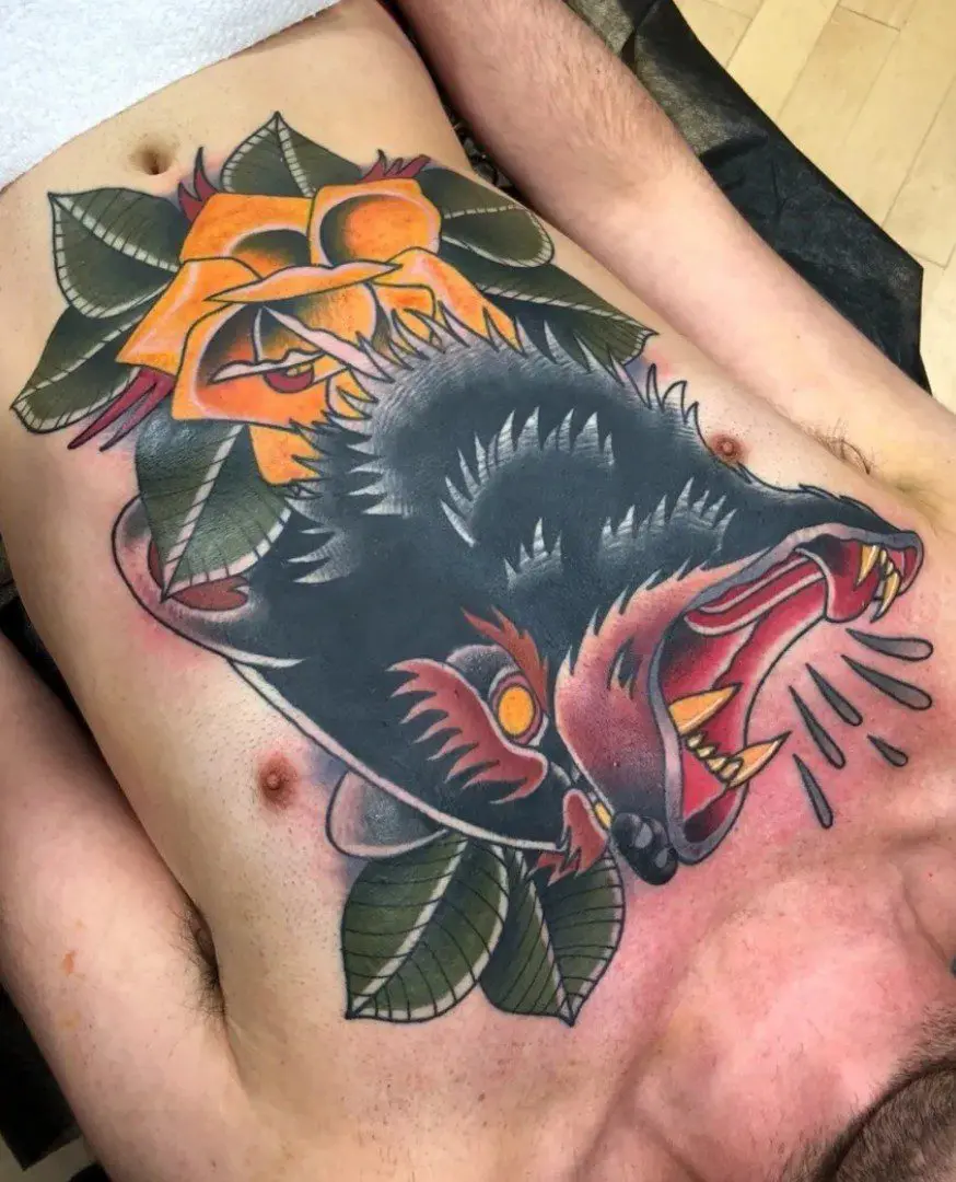 tattoo of a bear and leaves on a chest