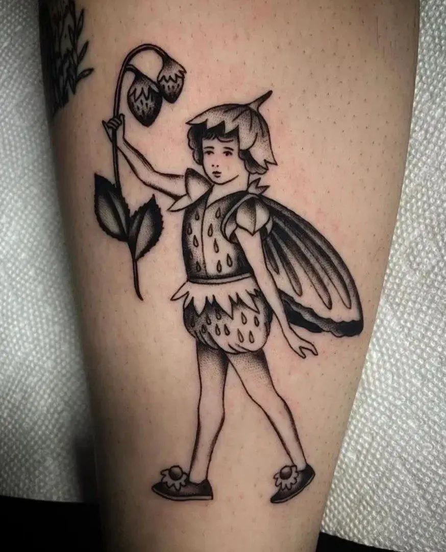 A black and white tattoo of a fairy holding a flower.