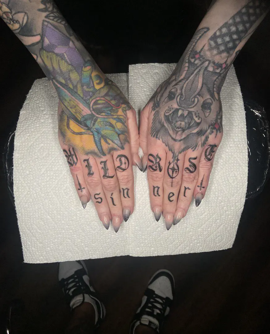 Lettering tattoos on fingers made in Philadelphia.