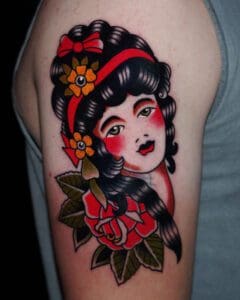 A tattoo of a woman with a flower. Best American Traditional Tattoo Artist