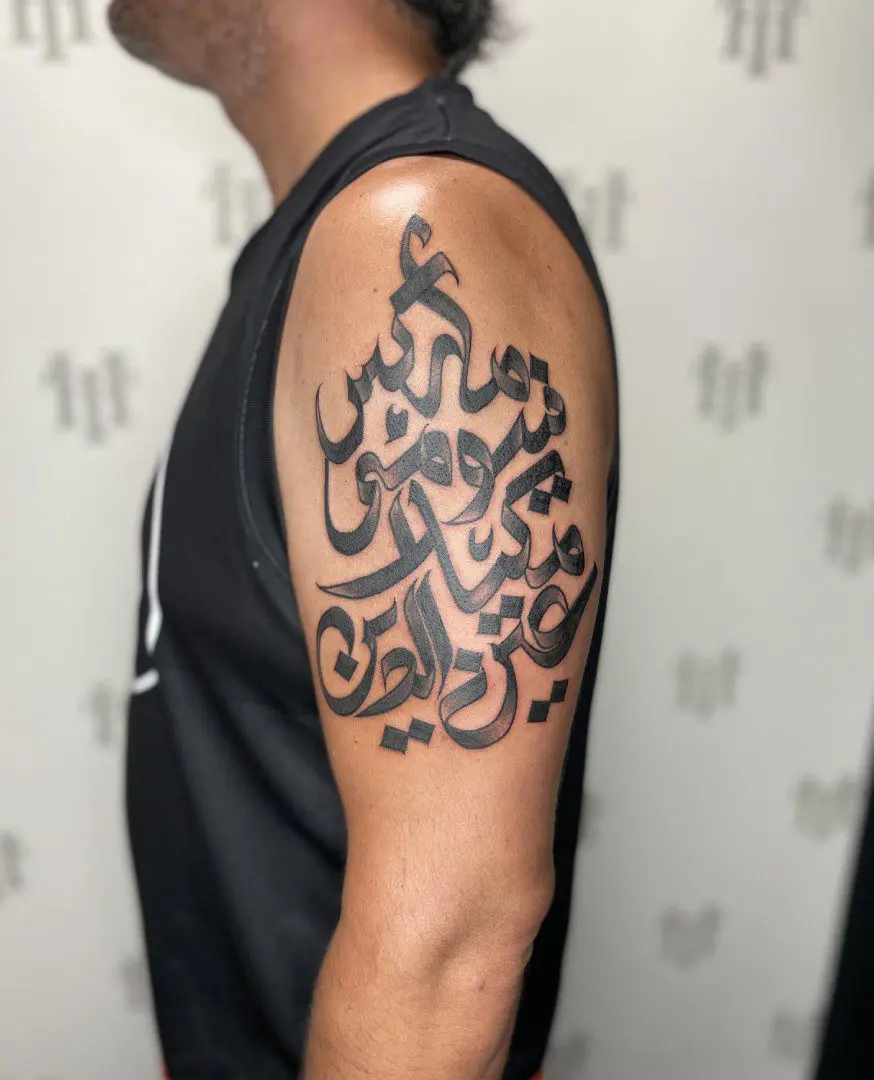 arabic lettering tattoo on arm.