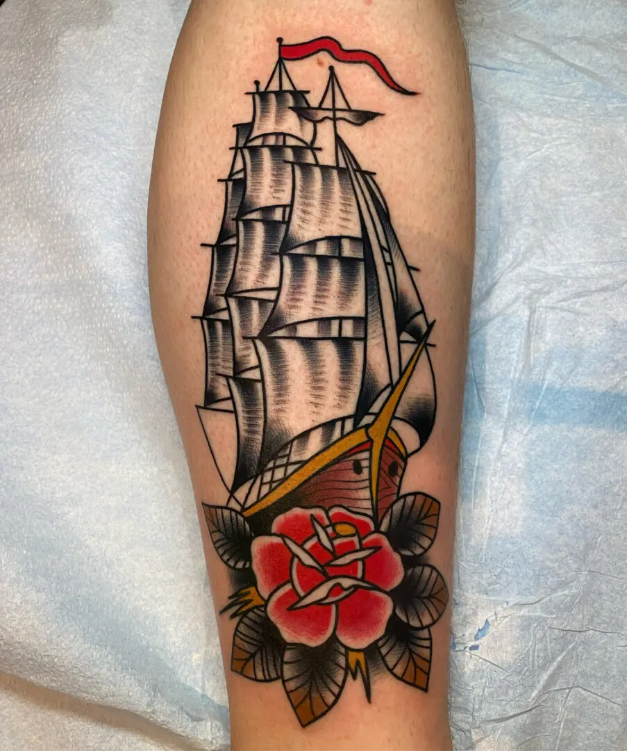 A tattoo of a ship with a rose on it. Best American Traditional Tattoo Artist - Myke Chambers