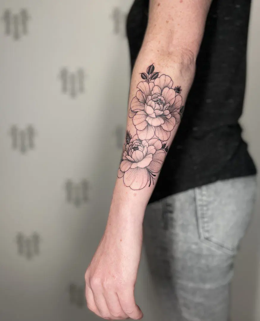Fine line floral tattoo on arm.