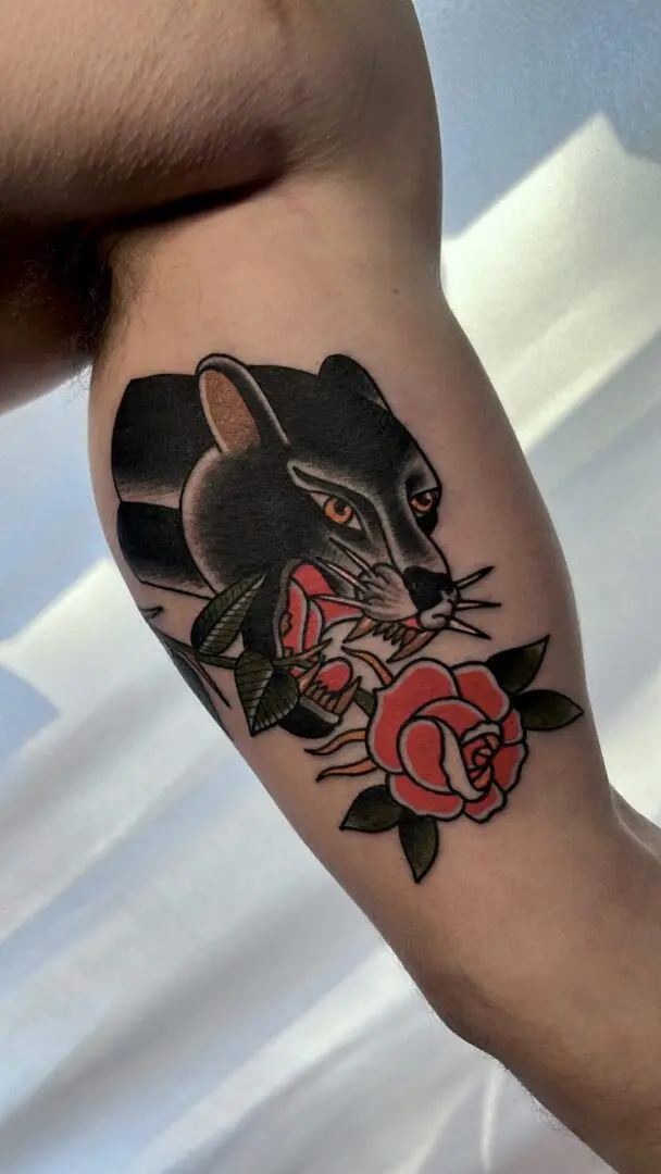 A tattoo of a panther with a rose. Best American Traditional Tattoo Artist