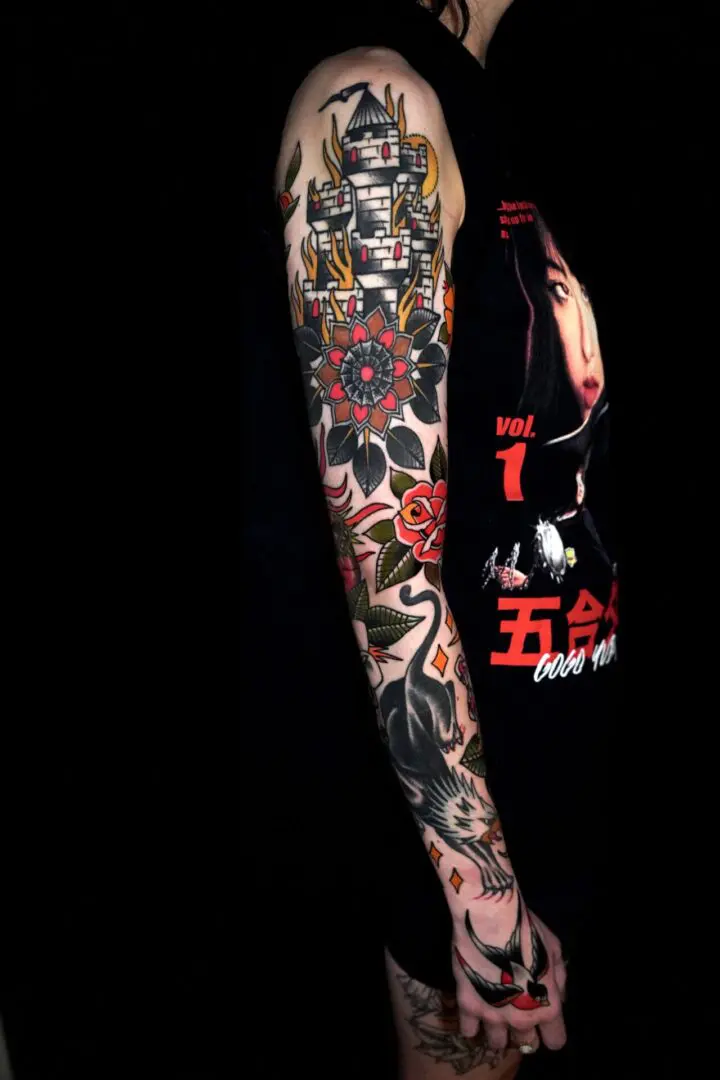 A woman with tattoos on her arms and legs. Best American Traditional Tattoo Artist- Myke Chambers