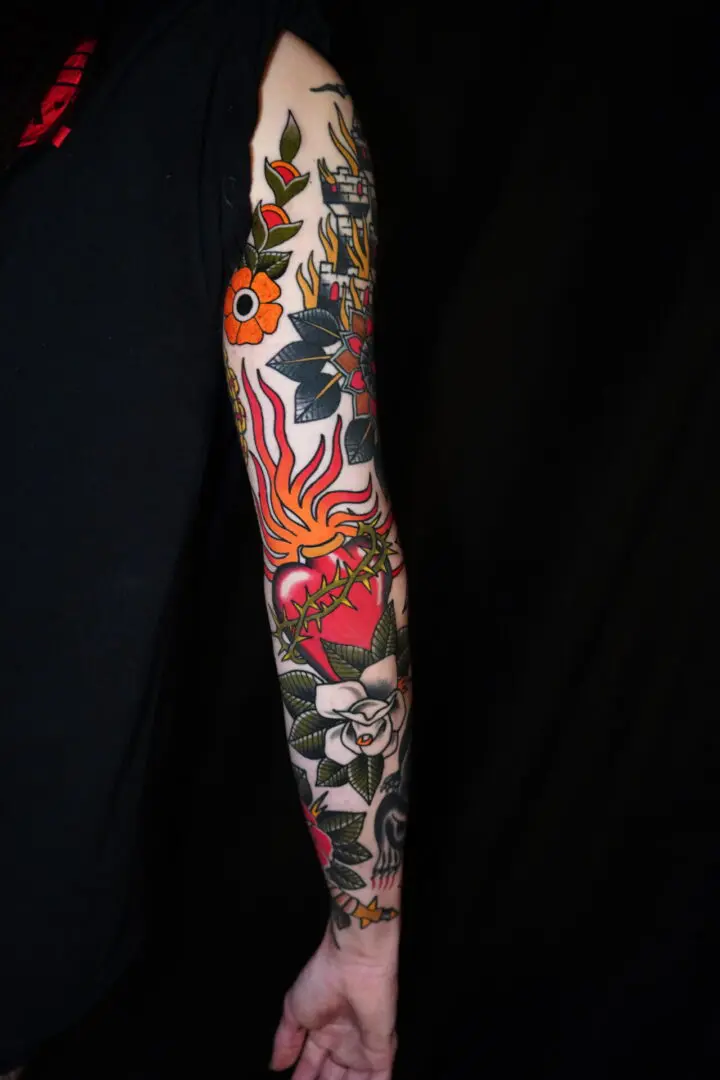 A person with a tattoo on their arm Best American Traditional Tattoo Artist- Myke Chambers