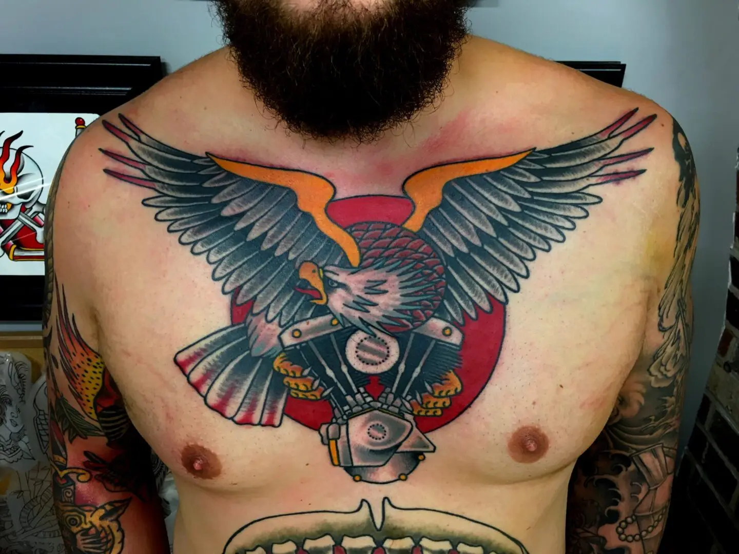 A man with a beard and tattoos on his chest. Best American Traditional Tattoo Artist - Myke Chambers