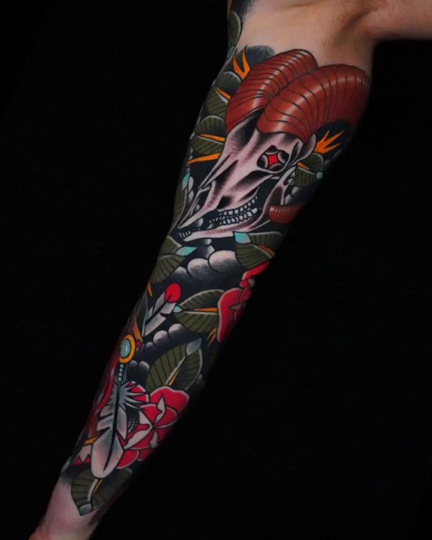 A tattoo of a dragon and flowers on the arm. Best American Traditional Tattoo Artist- Myke Chambers