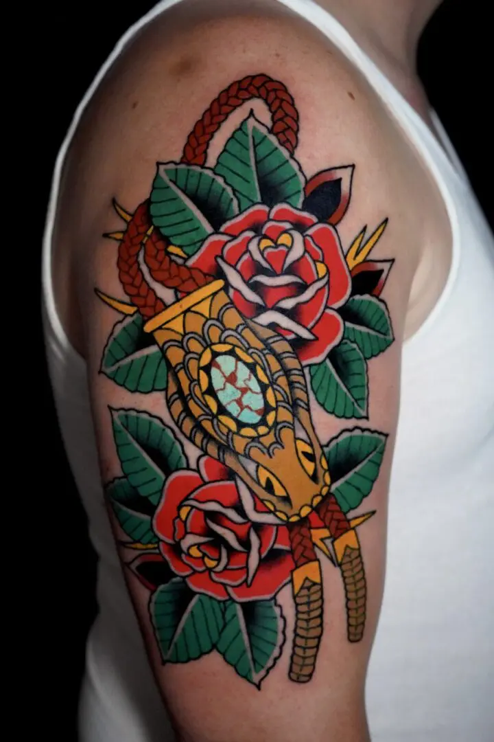 A tattoo of a clock and roses on the arm. Best American Traditional Tattoo Artist- Myke Chambers