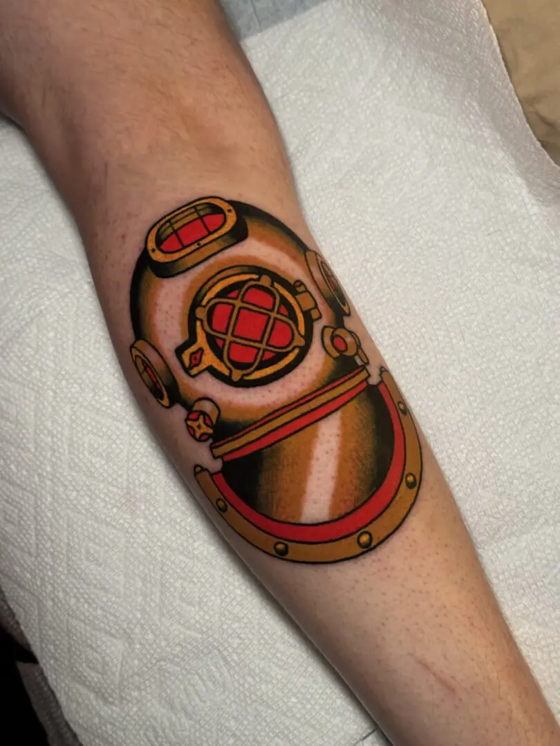 A tattoo of a diving helmet on the arm. Best American Traditional Tattoo Artist- Myke Chambers