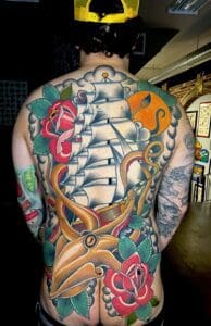 A man with a tattoo on his back Best American Traditional Tattoo Artist- Myke Chambers