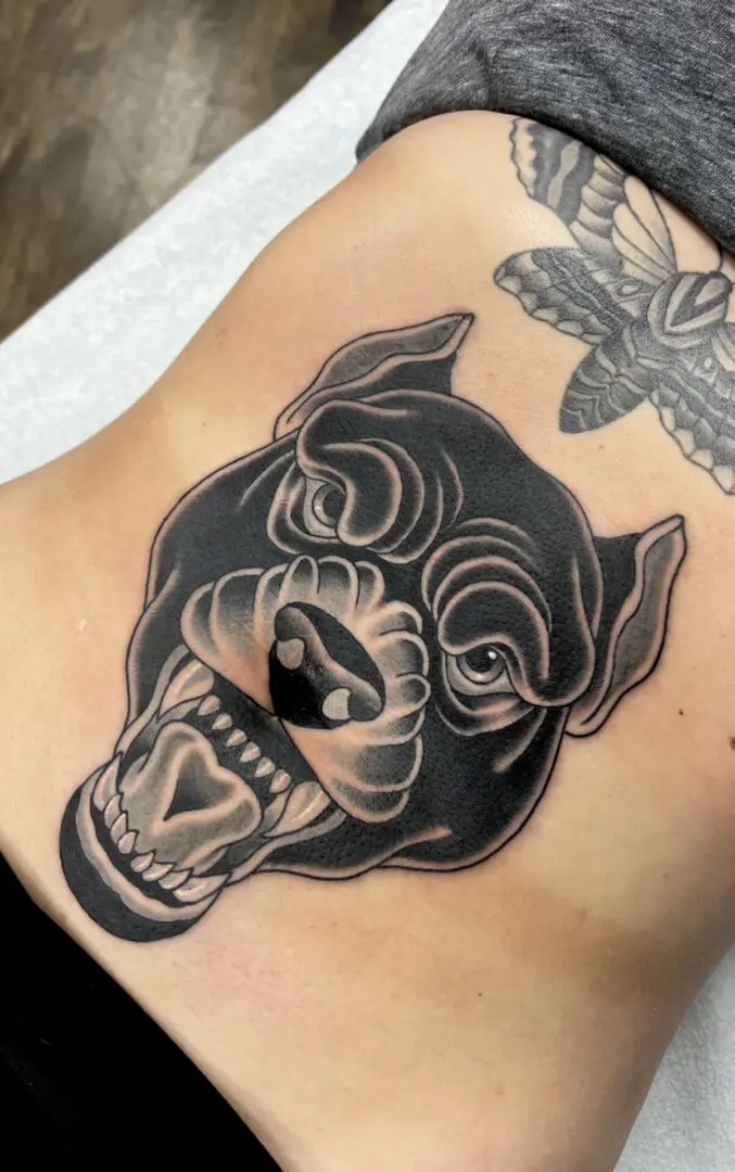 A black and greg tattoo of a pitbull. Best American Traditional Tattoo Artist- Myke Chambers