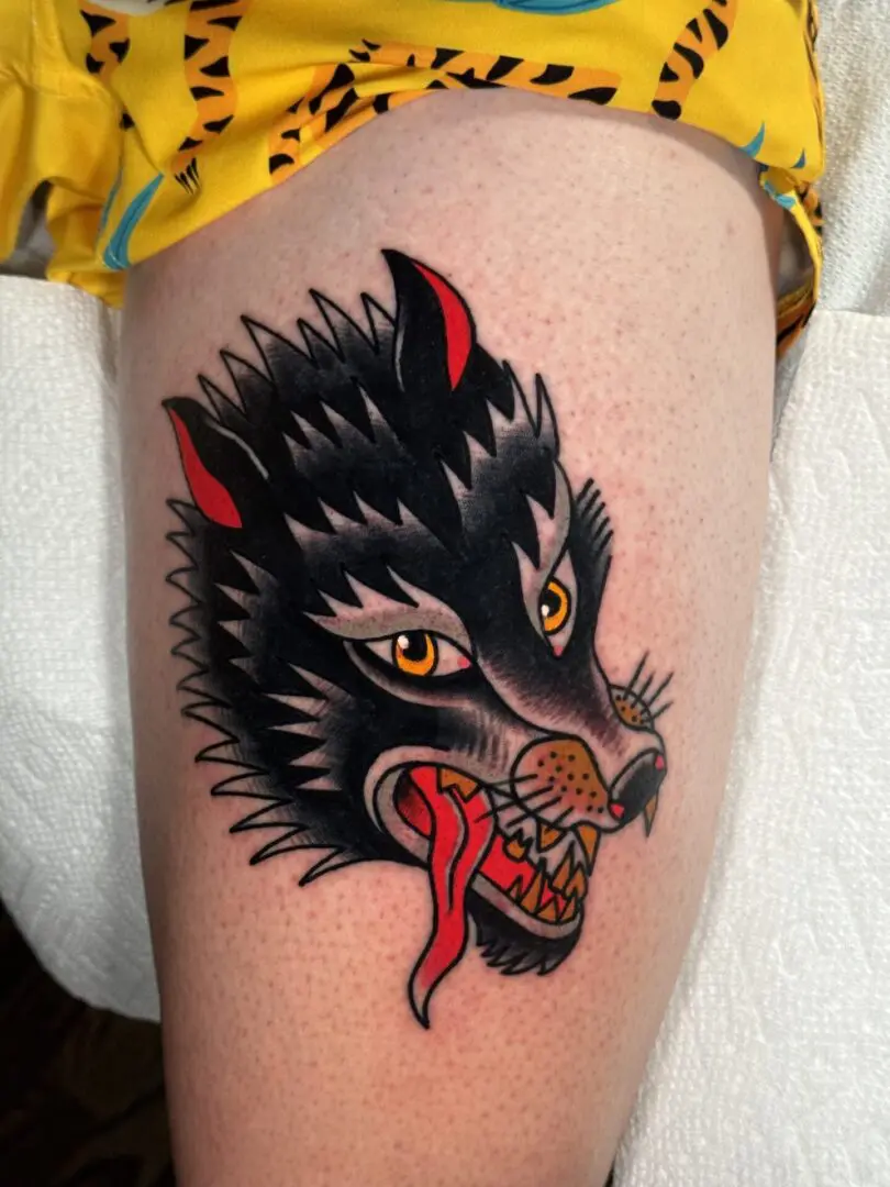 A traditional tattoo of a wolf with red eyes Best American Traditional Tattoo Artist- Myke Chambers