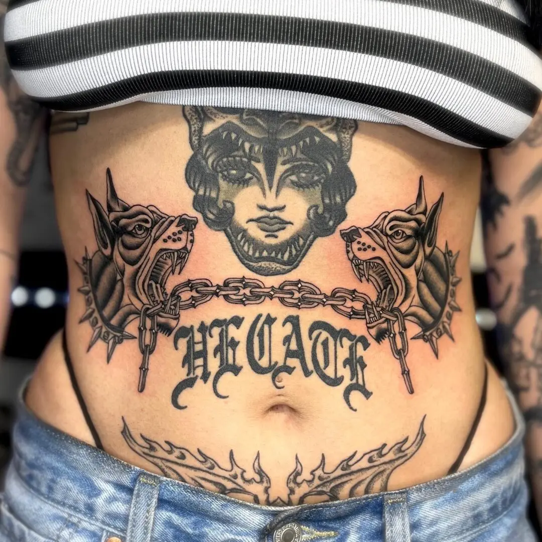 A woman with black and gray traditional tattoos on her stomach.
