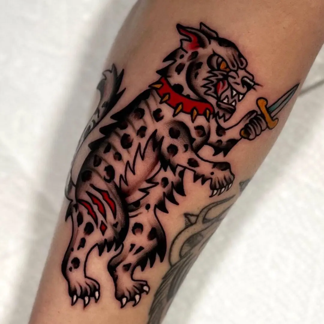 A tattoo of a cheetah holding a sword in black and gray traditional style.