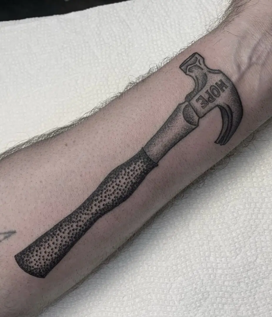Black and grey traditional hammer tattoo