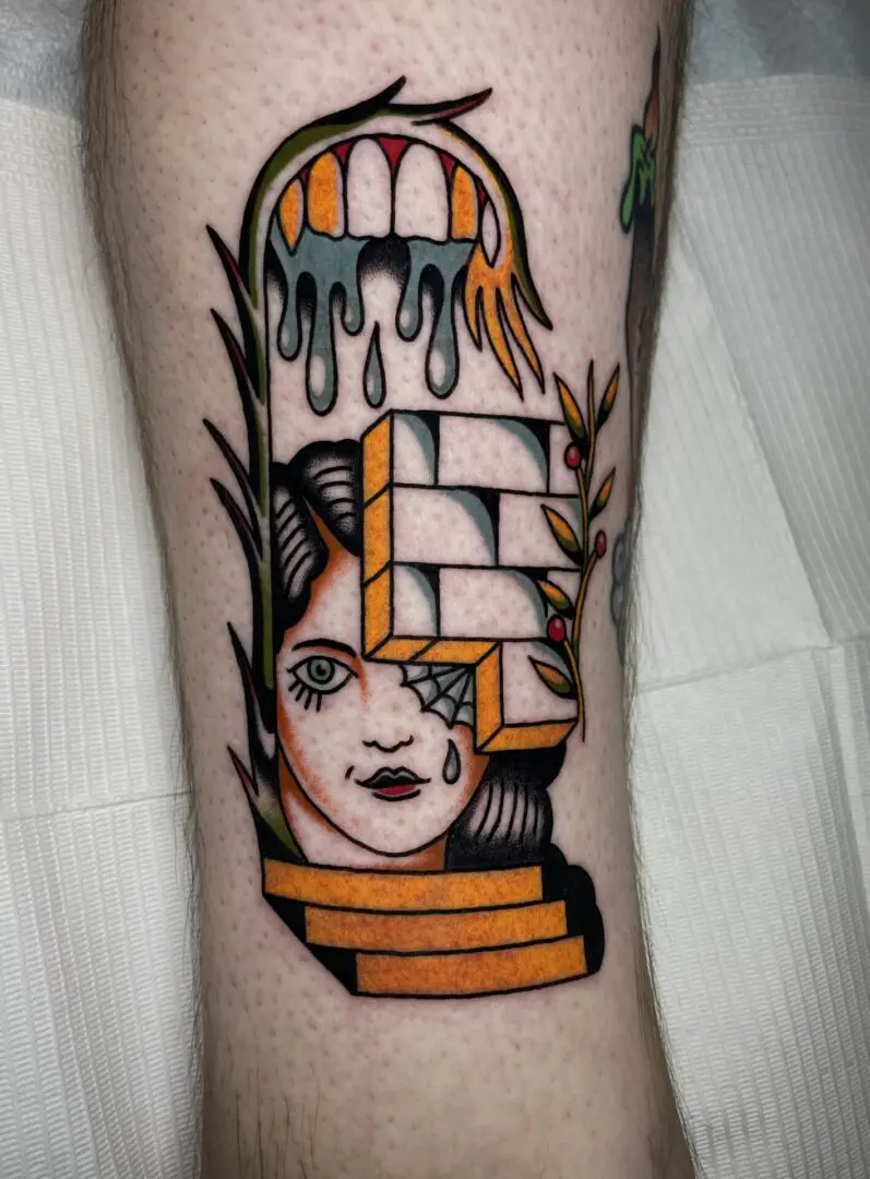 A tattoo of a woman inked by an Asheville Tattoo Artist on her leg.