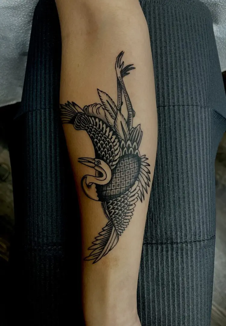 Black and grey bird tattoo on calf