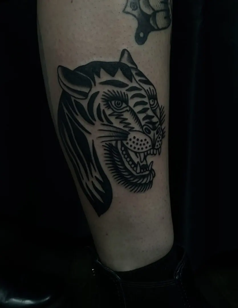a traditional tattoo of a tiger done in black and gray