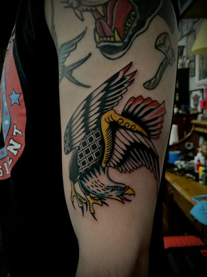 An eagle tattoo crafted by an Asheville tattoo artist on a man's arm.