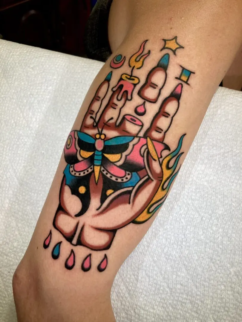 A bold tattoo of a hand with a star on it.