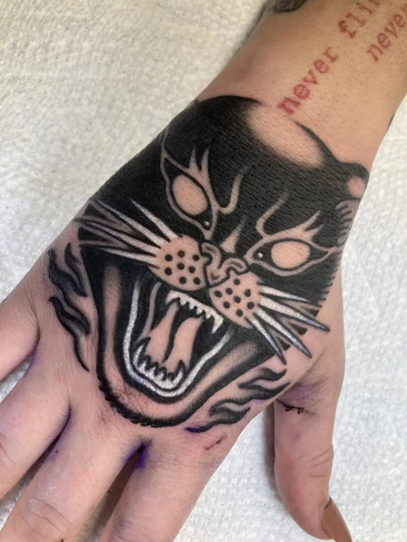 a tattoo of an angry black cat