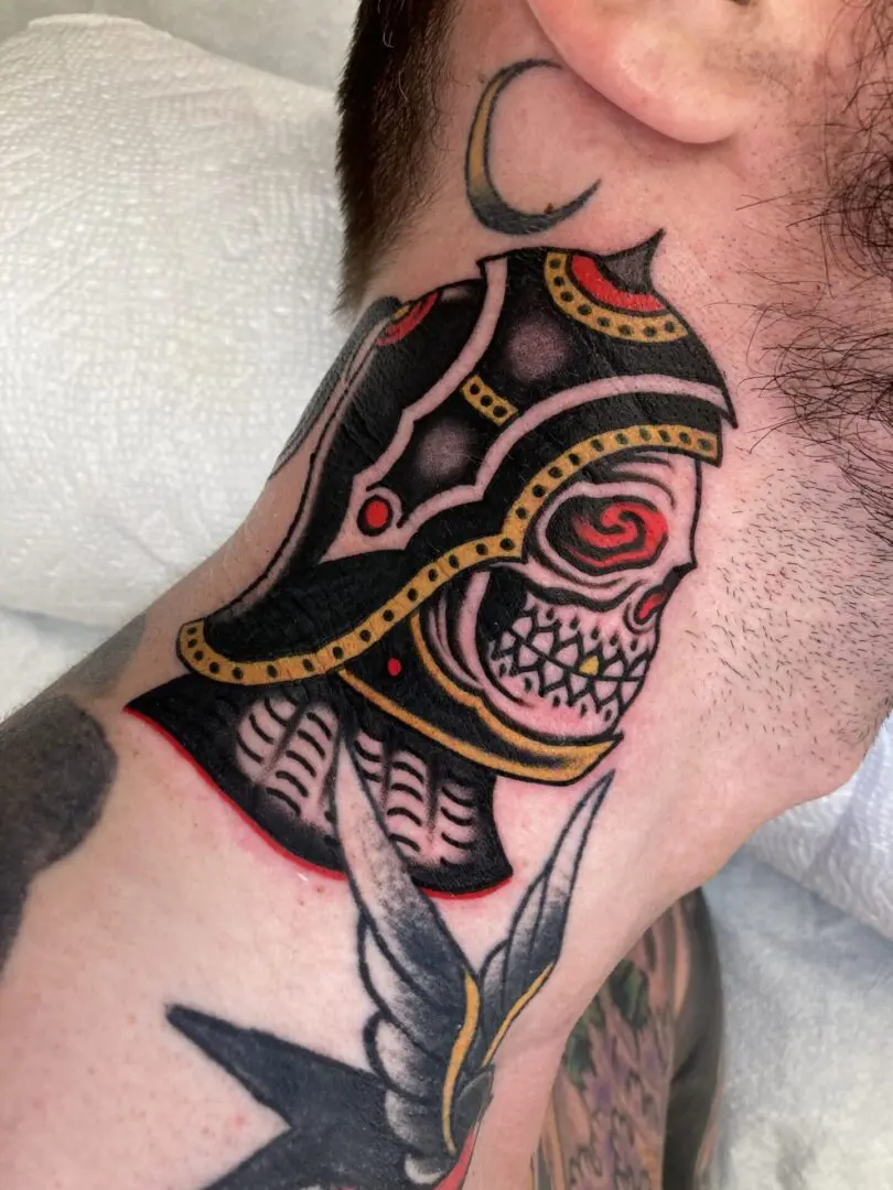 A man with a bold skull tattoo on his neck.