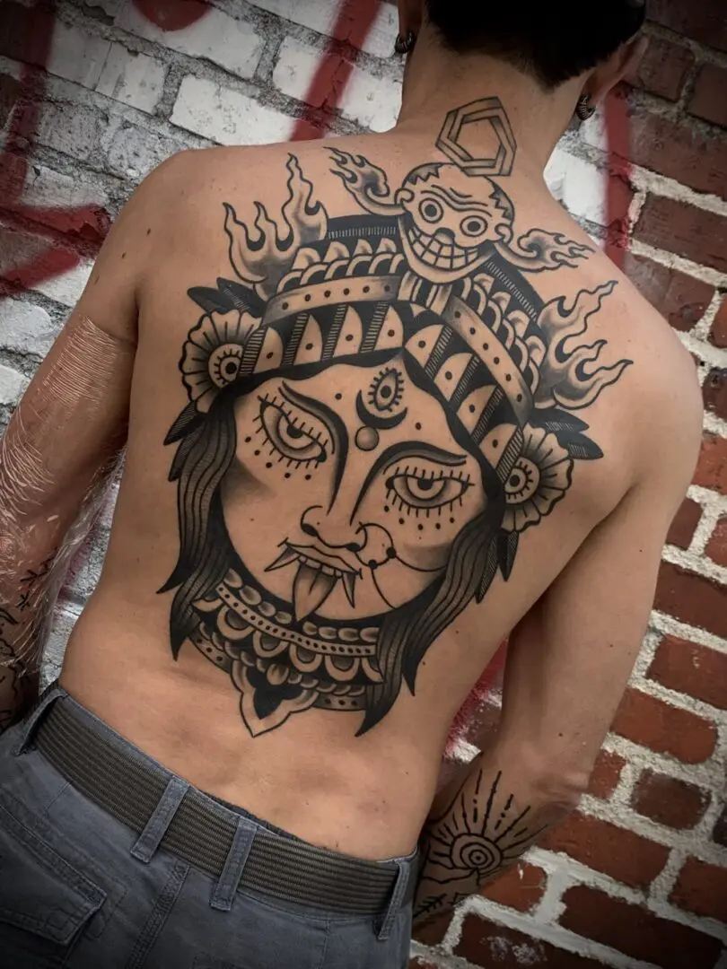 Tribal lion backpiece tattoo
