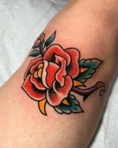 Traditional rose tattoo on knee