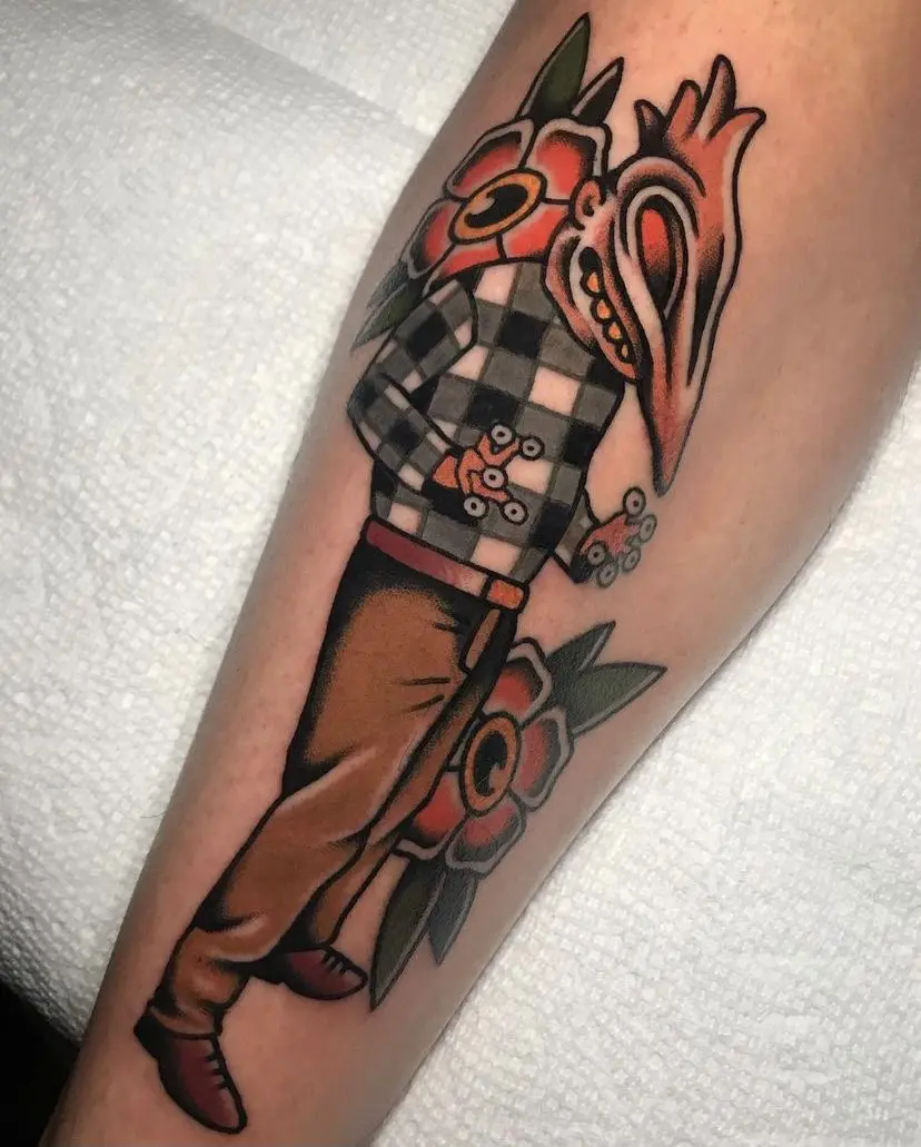 A bold tattoo of a man in a plaid shirt holding a flower.