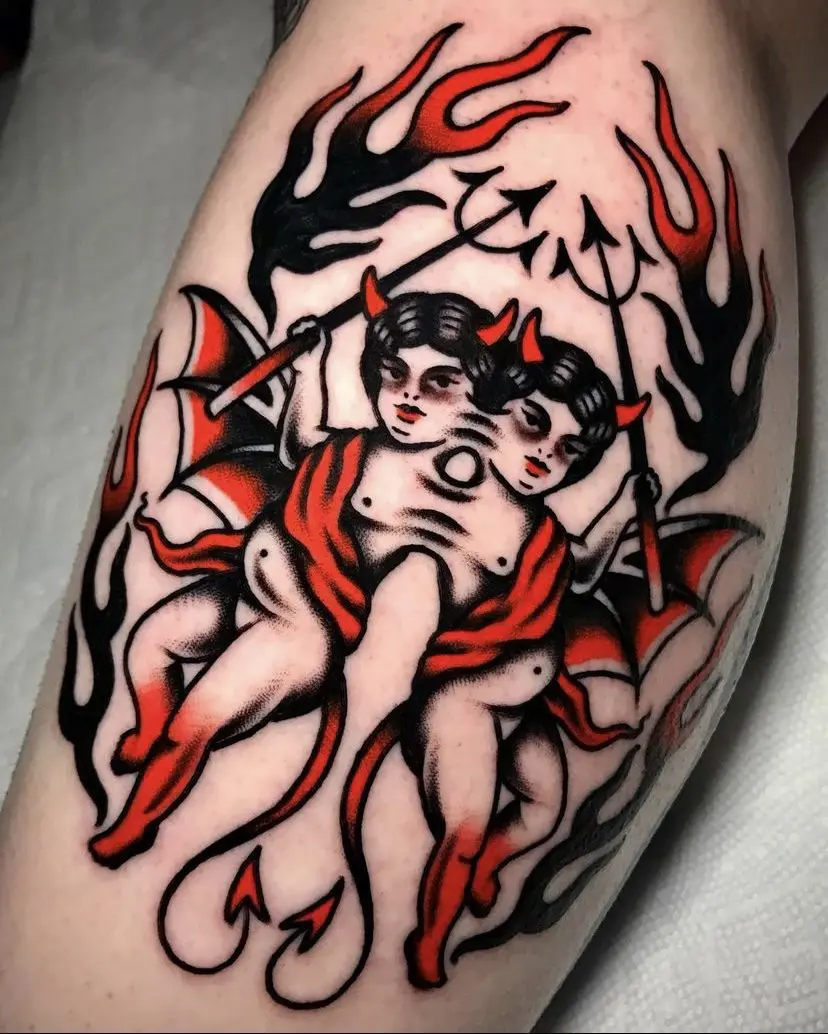 A tattoo of a devil with bold flames on his thigh.