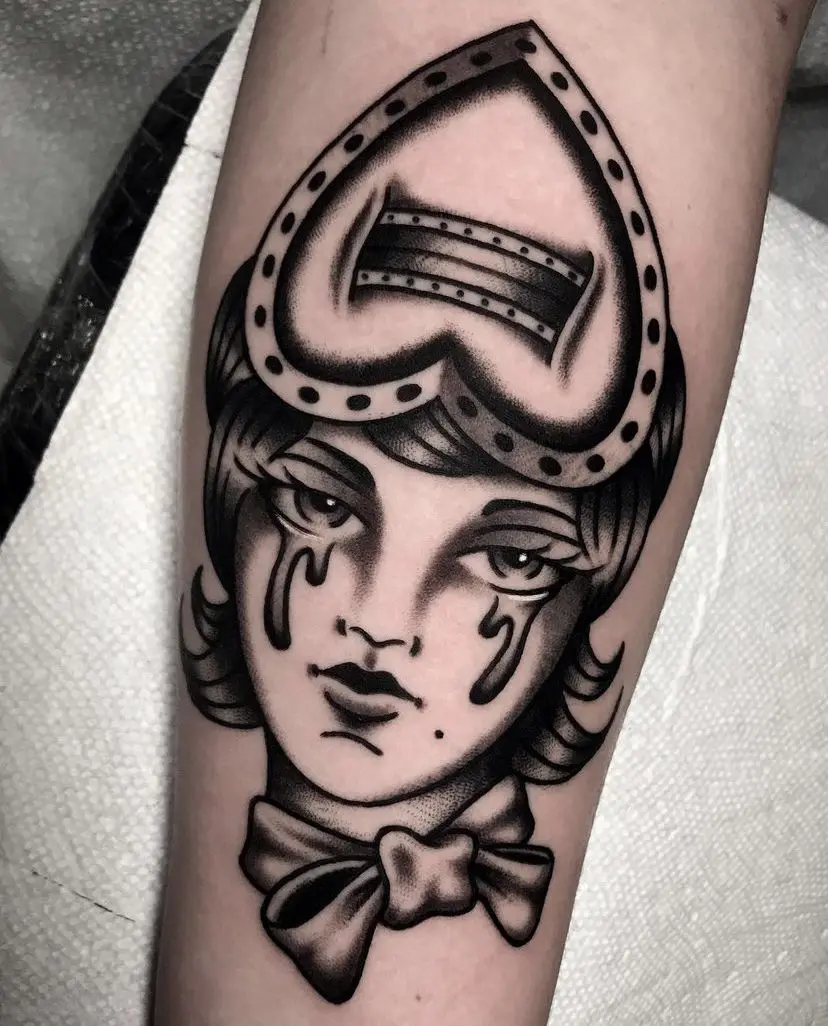 a black and gray tradtional ladyhead tattoo