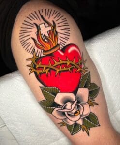 Sacred heart tattoo with rose design.