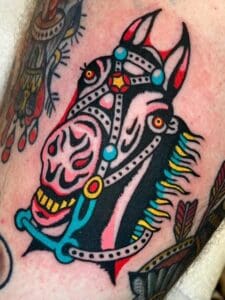 Tattoo of a horse on skin.